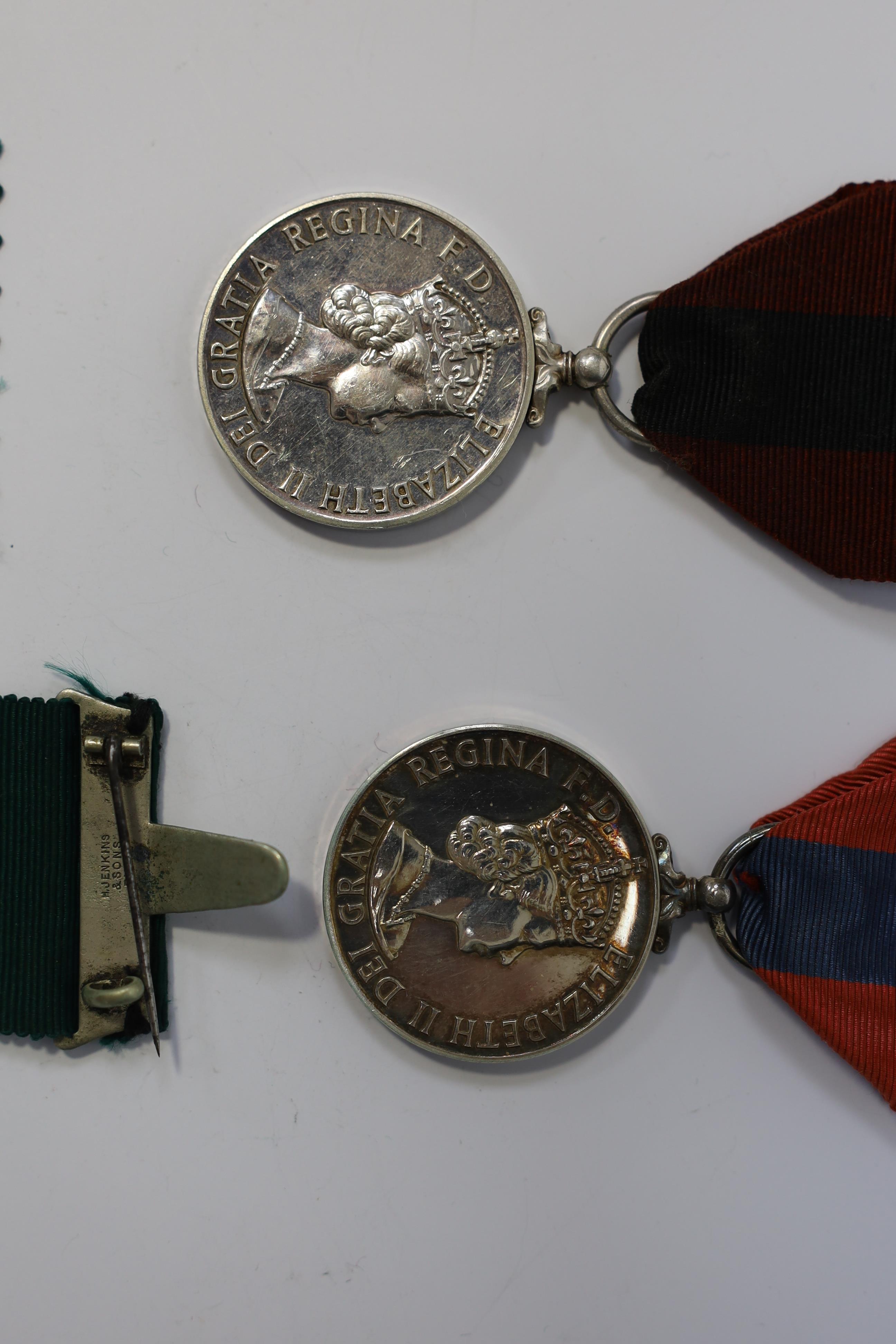 Four assorted Service medals; Vict unnamed Volunteer Long Service medal; GV Colonial Auxiliary Forces Long Service medal (disc only) to E.S.Ware; ERII ISM to Thomas Edward Downes; ERII ISM to William Henry Sharratt. Cond